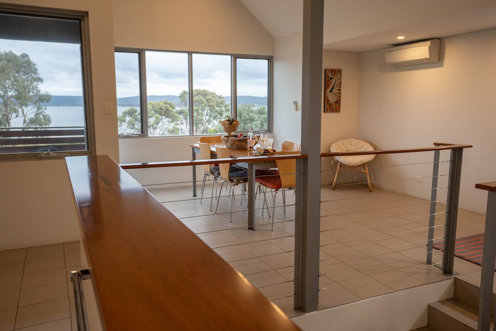 The dining area in the Lockyer Apartment with the view to Princess Royal Harbour through the large window.